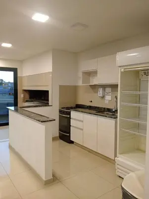 a large kitchen with white cabinets and appliances at Depto Centrico Etoile 4 in Villa Carlos Paz
