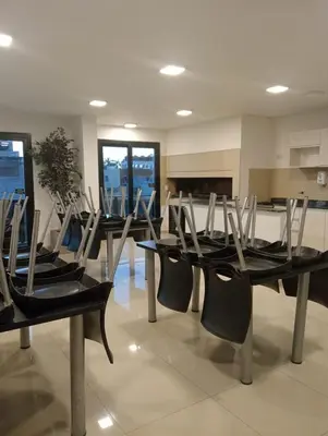 a group of chairs sitting around a table in a kitchen at Depto Centrico Etoile 4 in Villa Carlos Paz