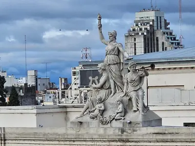 a statue of a woman on top of a building at Departamento Córdoba Semipiso frente a Patio Olmos in Cordoba