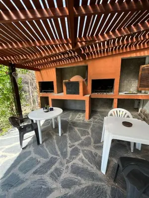a living room with two tables and a couch at Complejo El Viejo Nogal in Villa General Belgrano