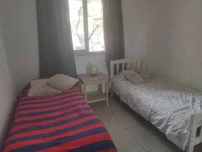 a bedroom with two beds and a window at dpto próximo patio olmos pileta in Cordoba