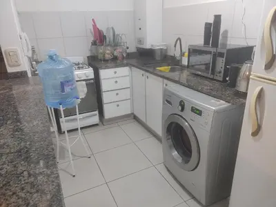 a kitchen with a washing machine and a washer at dpto próximo patio olmos pileta in Cordoba