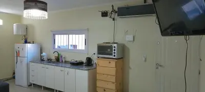 a kitchen with a refrigerator freezer and a microwave at El cruce - el trapiche in Trapiche