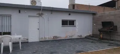 a white building with a table and a sink at El cruce - el trapiche in Trapiche