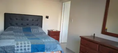 a bedroom with a bed and a dresser and a mirror at El cruce - el trapiche in Trapiche