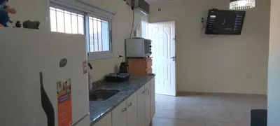 a kitchen with a white refrigerator and a sink at El cruce - el trapiche in Trapiche