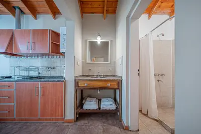 a kitchen with a sink and a shower in a room at Cabañas Montecarlo 2 in Santa Rosa de Calamuchita