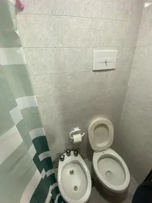 a small bathroom with a toilet and a bidet at Departamento cómodo en Córdoba Capital in Cordoba