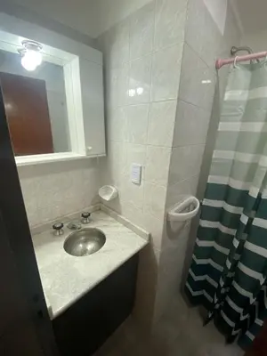 a bathroom with a sink and a shower at Departamento cómodo en Córdoba Capital in Cordoba