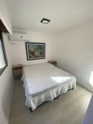 a bedroom with a bed in a white room at Departamento cómodo en Córdoba Capital in Cordoba