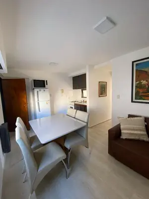 a living room with a white table and a couch at Departamento cómodo en Córdoba Capital in Cordoba