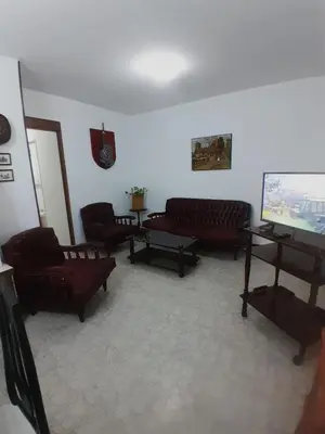 a living room with couches and a piano at Departamento en Río Cuarto Cba in Río Cuarto