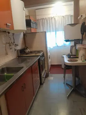 a small kitchen with a sink and a stove at Departamento en Río Cuarto Cba in Río Cuarto