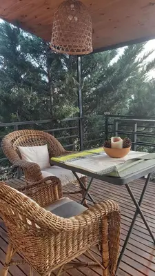 a patio with a table and chairs on a deck at Paz in Tanti
