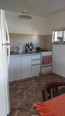 a kitchen with white cabinets and a stove at Paz in Tanti