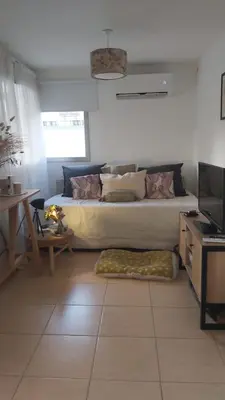 a bedroom with a bed and a table and a television at Paz in Tanti