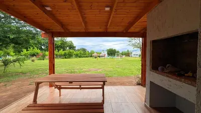a wooden porch with a bench and a fireplace at Cabañas Vida Paz in Las Calles