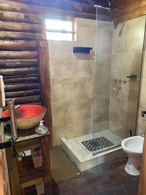 a bathroom with a shower and a sink at Cabaña Rincón de los Pájaros San Ignacio Cordoba in San Ignacio