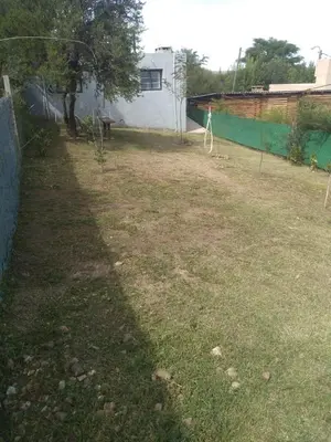 a yard with a fence and a tree in it at Portal del rio in Mina Clavero