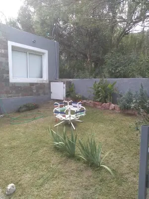 a picnic table in the yard of a house at Portal del rio in Mina Clavero