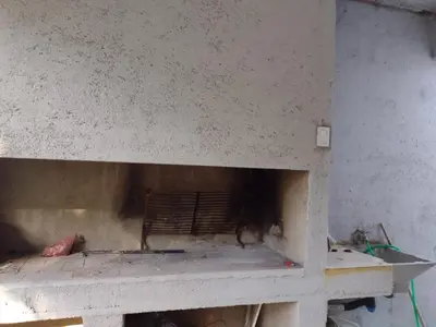 a concrete wall with a fireplace in a room at Portal del rio in Mina Clavero
