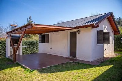 a house with a large patio in the yard at Cabañas Montecarlo 3 in Santa Rosa de Calamuchita