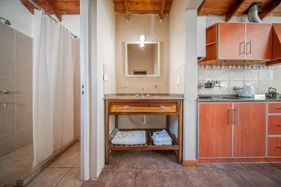 a kitchen with a sink and a counter top at Cabañas Montecarlo 3 in Santa Rosa de Calamuchita