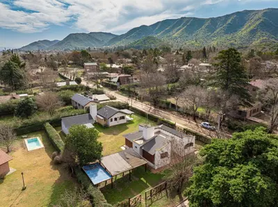 an aerial view of a village with mountains in the background at Cabañas Montecarlo 3 in Santa Rosa de Calamuchita