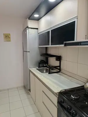 a small kitchen with a sink and a refrigerator at Departamento en zona Güemes in Cordoba
