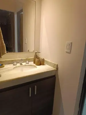 a bathroom with a sink and a mirror at Departamento en zona Güemes in Cordoba