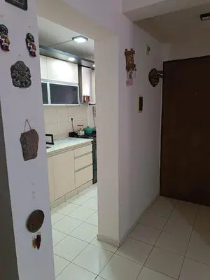 a kitchen with a door leading into a room with a counter at Departamento en zona Güemes in Cordoba