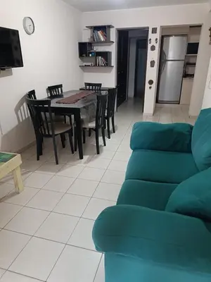 a living room with a couch and a table and chairs at Departamento en zona Güemes in Cordoba