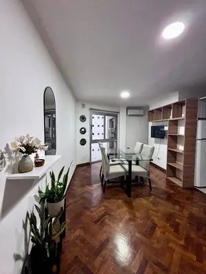 a kitchen and dining room with a table and chairs at Departamento Frente Campus UNC in Cordoba