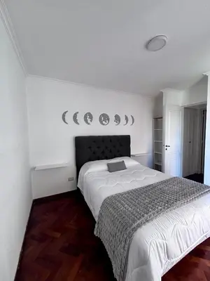 a bedroom with a bed and mirrors on the wall at Departamento Frente Campus UNC in Cordoba