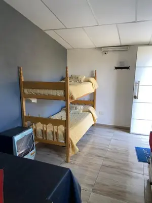 two bunk beds in a room with a tv at La loreta in Mina Clavero