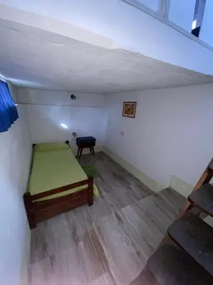 a room with a bed and a table in it at La loreta in Mina Clavero