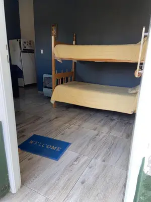 a room with two bunk beds and a blue floor at La loreta in Mina Clavero