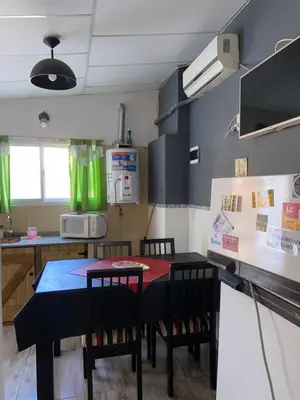 a kitchen with a table and chairs in a room at La loreta in Mina Clavero