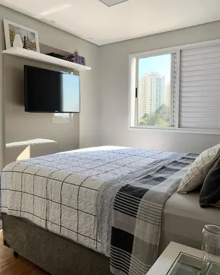a bedroom with a bed with a tv and a window at Villa serrana in Mina Clavero