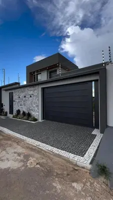 a house with a garage door on the side of it at Villa serrana in Mina Clavero