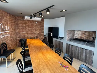 a conference room with a long wooden table and chairs at Rent a flat - Alto Paz Tower in Cordoba