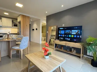 a living room with a tv and a kitchen at Rent a flat - Alto Paz Tower in Cordoba