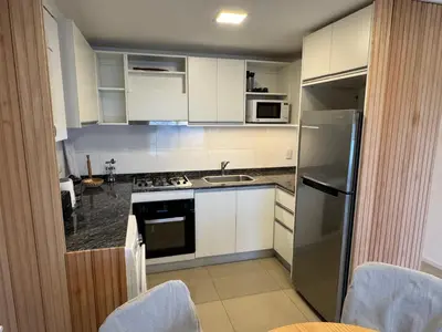 a kitchen with white cabinets and a stainless steel refrigerator at Rent a flat - Alto Paz Tower in Cordoba