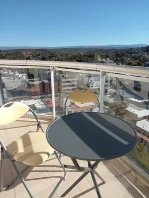 a table and chairs on a balcony with a view at alquileresmdqycarlospaz in Villa Carlos Paz