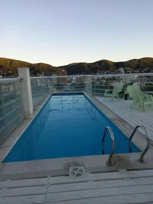 a swimming pool on the roof of a building at alquileresmdqycarlospaz in Villa Carlos Paz