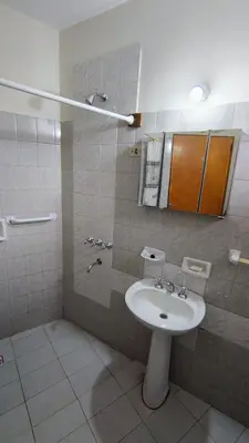 a bathroom with a white sink and a mirror at Dpto Marina in Villa Cura Brochero