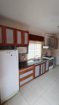 a kitchen with a refrigerator and a sink at Dpto Marina in Villa Cura Brochero