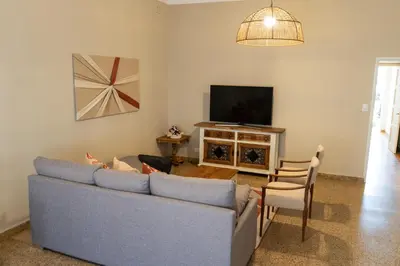 a living room with a couch and a tv at Aires del Casco in La Porteña