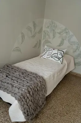 a bed with a blanket and pillows on it at Aires del Casco in La Porteña