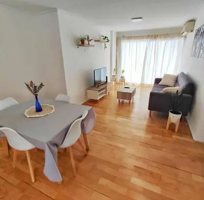 a living room with a table and a couch at Departamento en calle Independencia in Cordoba